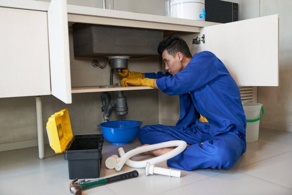 hite vinegar and baking soda being used to clean the inside of a dishwasher naturally.