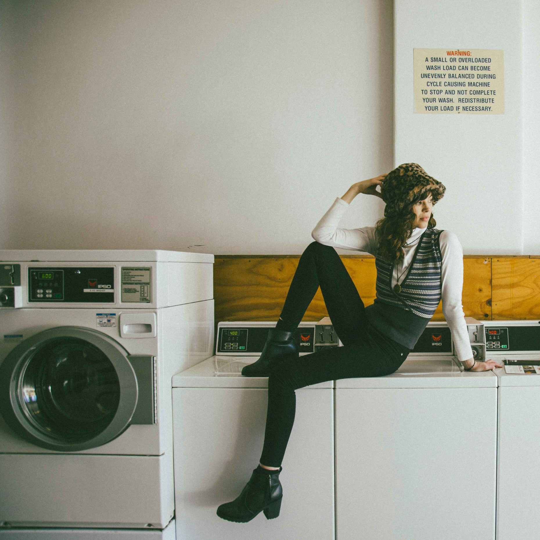 woman inspecting dirty washing machine drum before cleaning