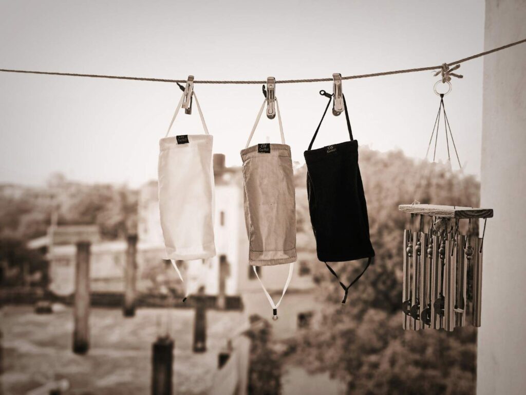 Clothes hanging on rack while preparing to steam wrinkles out