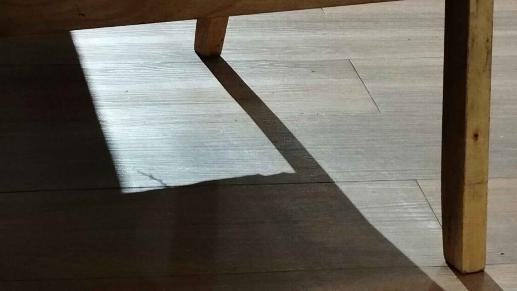 wooden table with visible scratches showing need for restoration